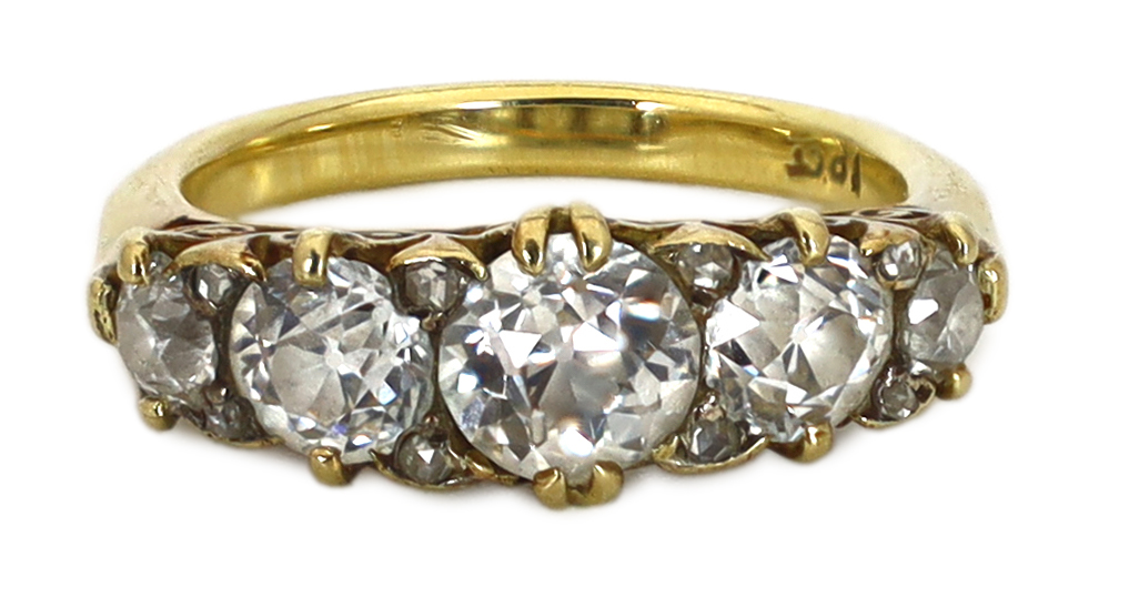 An early 20th century 18ct gold and graduated old round cut diamond set half hoop ring